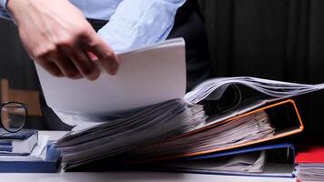 man puts documents in a binder folder. Office worker archives documents. office worker studies a contract, document in the archive concept of storing documents in the archive video