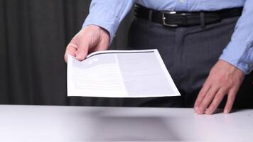 Confident businessman handing resume to hiring manager in office setting, showcasing skills and qualifications. Crucial step in job interview process. Businessman giving resume video