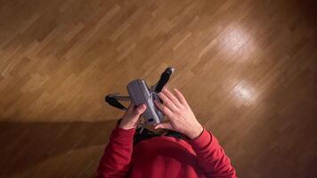 pov, first person view. Man unfolds modern compact folding quadcopter drone. Preparing drone for flight. Person mounting propellers on a gray foldable quadcopter drone video