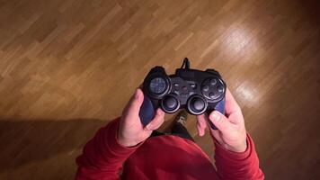 pov first person view Man shows his console controller. Gamer is ready to start playing games. Concept of gamer on console. Cozy setting for playing games video