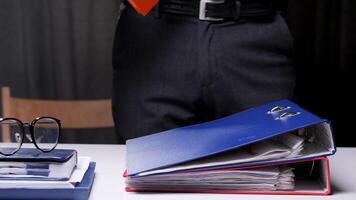 Heavy routine monotonous office work with documents. Archive of documents in a stack. An office worker irritably dumps folders with documents on his desk. daily routine work in the office video