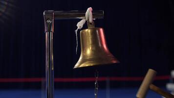 close up of a boxing referee hitting the boxing bell with a hammer mallet. A referee signals the start or end of a round or a boxing match with the sound of a boxing bell. Concept of start or finish video