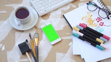 A cup of coffee and a notebook are on a table with a keyboard and a mouse, perfect for creating a cozy workspace, ideal for remote work, digital content creation, and productivity tasks video