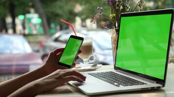 A woman is using a laptop with a green screen ideal for digital content creation remote work E commerce and online tasks perfect for showcasing technology digital marketing and creative projects video