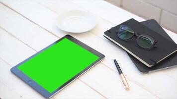 Tablet with Green Screen and Pen on a Wooden Table Perfect for Digital Design E Commerce and Creative Projects video