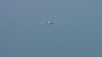 Jet commercial aircraft approaching to landing. Footage of an airliner descending. Airplane in the sky, front view, long shot video