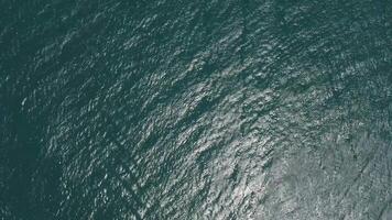 Aerial yacht on calm sea. Luxury cruise trip. View from above of white boat on deep blue water. Aerial view of rich yacht sailing sea. Summer journey on luxury ship. Vertical video