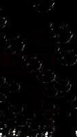 Many light bulbs lighting up. Dark background with lamps becomes bright. Beautiful ceiling with round glass lamps switches on. Vertical video