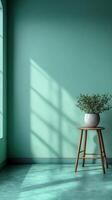 serene pastel green studio background featuring wooden stool and potted plant, creating calm and inviting atmosphere with soft shadows photo