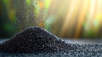 pile of black sesame seeds with sparkling particles against blurred background, creating vibrant and dynamic atmosphere photo