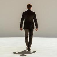 businessman in suit walks confidently, casting long shadow on minimalist background. scene conveys professionalism and determination photo