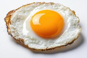 single large egg yolk with rich golden color, surrounded by crispy white edges, creates delicious and appetizing visual. Perfect for culinary presentations photo