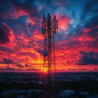 telecommunication network tower stands tall against vibrant sunset, surrounded by dramatic clouds. scene captures beauty of technology and nature in harmony photo