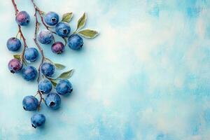 Fresh blueberries on branch with green leaves against soft blue background, creating vibrant and refreshing visual. Perfect for food related themes photo
