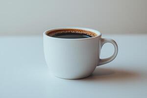 Freshly brewed cup of coffee with rich dark color and smooth surface. Perfect for cozy morning or afternoon break, this cup invites relaxation and enjoyment photo