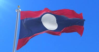 Flag of Laos waving at wind with blue sky in slow, loop video
