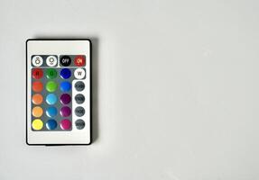 RGB lamp wireless remote control with colorful buttons isolated on horizontal ratio copy spaced white background. photo