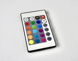 RGB lamp wireless remote control with colorful buttons isolated on horizontal ratio white background. photo