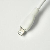 White charging data cable mobile phone plug isolated on square white background. photo