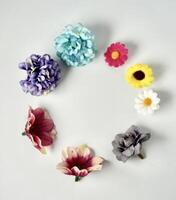 Decorative colorful small flowers frame border display object isolated on vertical copy spaced white background. photo