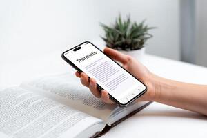 Phone in hand displaying book translation app with OCR scanning concept. Ideal for themes of language learning, translation technology, reading, and digital education photo
