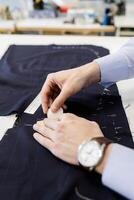 Tailor using chalk on fabric photo