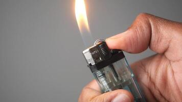 A Hand Firmly Gripping a Lighter with a Flames that has Been Successfully and Safely Ignited video