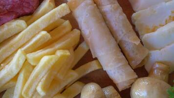 A scrumptious platter of fried snacks featuring crispy fries and a variety of fresh ingredients video