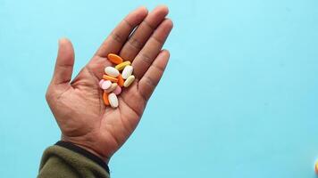 A Beautiful Handful of Colorful Pills Displayed Against a Bright Blue Background video