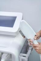 Close-up of a modern aesthetic laser device in a dermatology clinic setting for advanced skincare treatments. photo