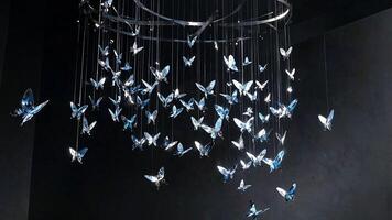 Crystal butterfly chandelier suspended in a circular frame, reflecting light for a modern and elegant visual experience. photo