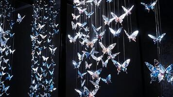 Crystal butterflies hang in an artistic installation reflecting light in a mesmerizing display photo