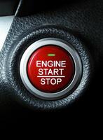 Close up of engine start stop button on car dashboard photo