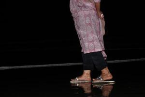 A woman standing on the beach at night photo