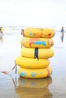 A row of yellow life rings on the beach photo