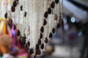 A hanging necklace with beads and shells photo