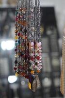 A bunch of necklaces hanging on a rack photo