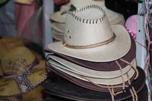 Straw hats for men sold in the shop. interior. Men's winter hats.Typical ecuadorian hats from the sierra in different colours photo