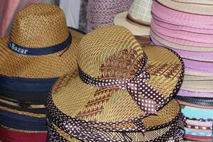 Straw hats for men sold in the shop. interior. Men's winter hats.Typical ecuadorian hats from the sierra in different colours photo