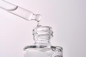 Close-up of a cosmetic bottle with a pipette showing the texture of the serum. photo