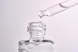 Close-up of a cosmetic bottle with a pipette showing the texture of the serum. photo