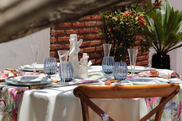 sophisticated and colorful table setting for lunch in the garden