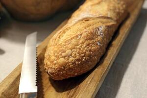natural fermentation baguette and knife on the table photo