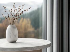 Minimalist vase with dried flowers on marble table by window photo