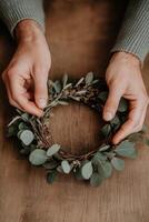 Making a fresh eucalyptus wreath for home decor during autumn photo