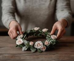 Creating a beautiful flower crown with delicate roses and greenery photo