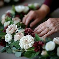 Hands arranging a beautiful floral crown with soft colors and texture photo
