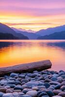 Stunning sunset over tranquil lake with rocky shore and mountains photo