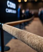 Event registration area with a focus on a velvet rope barrier photo