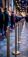 Long queue of people waiting in a dimly lit venue during evening hours photo
